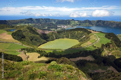 View into the volcanic crater Caldera Sete Cidades, in front of the crater lake Lagoa de Santiago, in the back right crater lakes Lagoa Azul, in the back left the village Sete Cidades, island Sao Miguel, Azores, Portugal, Europe