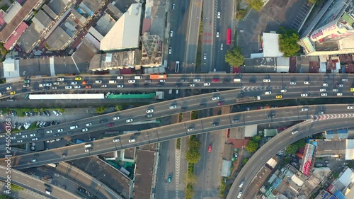 Top view of elevated expressway. Beautiful aerial shot of the curve of suspension bridge in daytime in Bangok, Thailand. Scenic road, big city life and transportation concept. photo