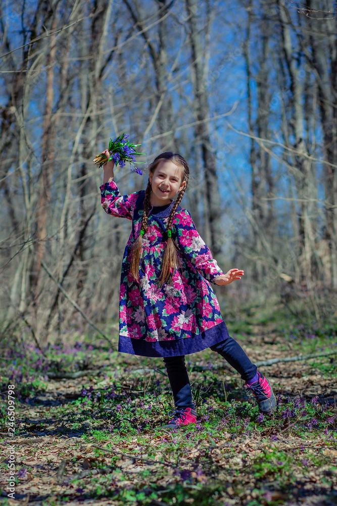 Portrait of a beautiful little girl with corydalis flowers. Portrait of a beautiful little girl with corydalis flowers.