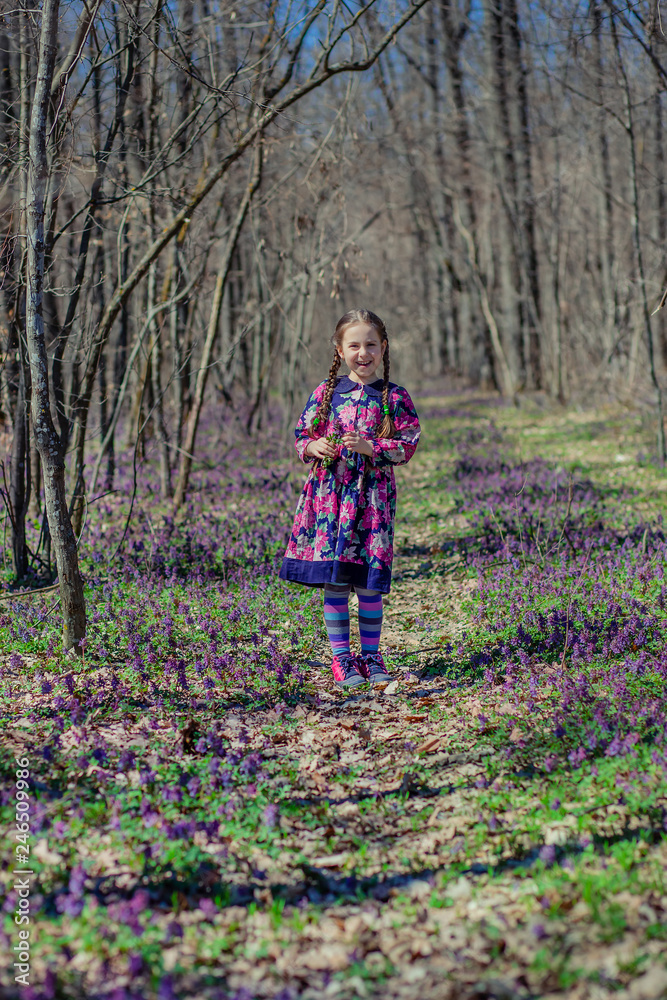 Portrait of a beautiful little girl with corydalis flowers. Portrait of a beautiful little girl with corydalis flowers.