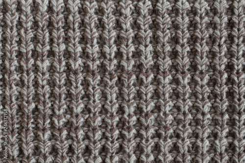 White with brown melange woolen knitted fabric texture. Macro.
