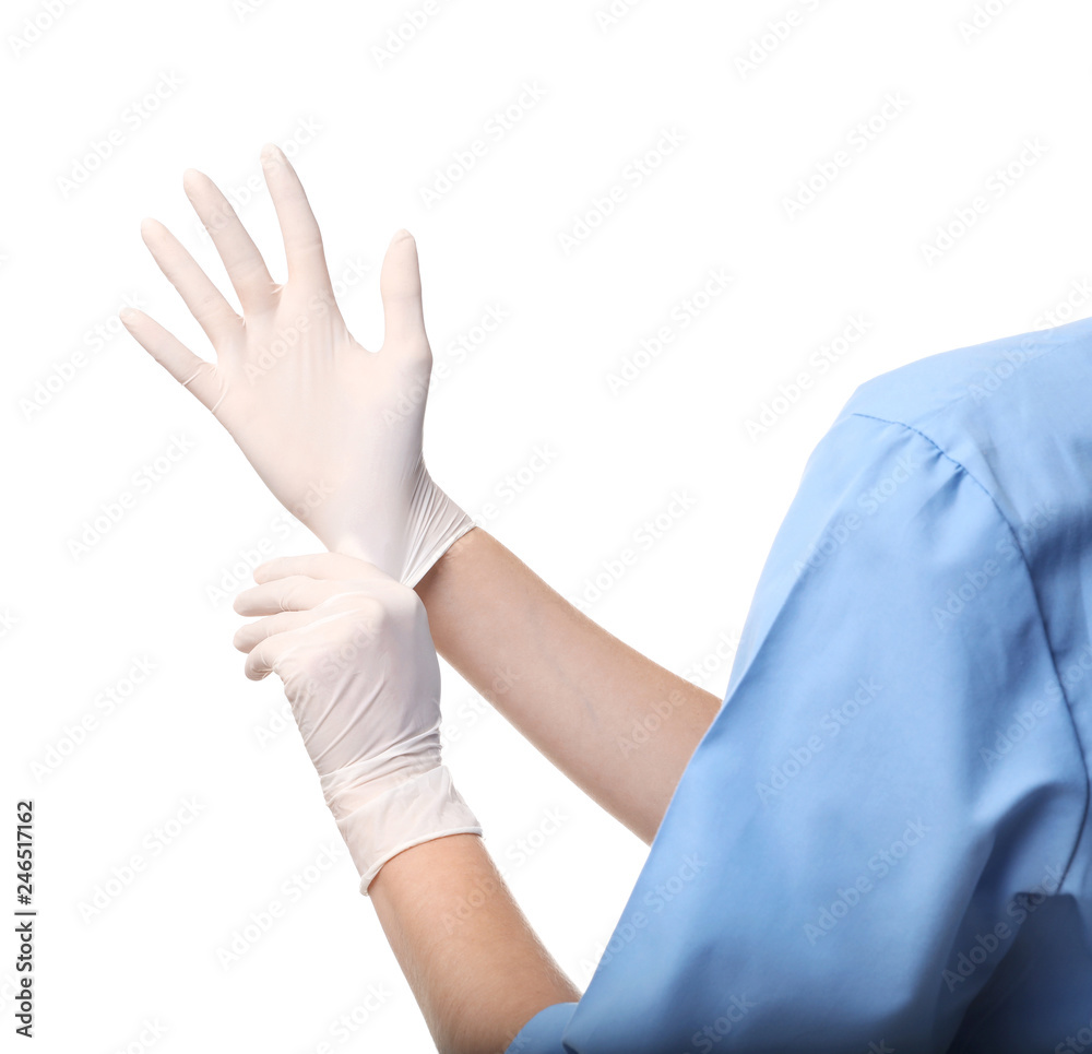 Female doctor putting on rubber gloves against white background, closeup. Medical object Female doctor putting on rubber gloves against white background, closeup. Medical object