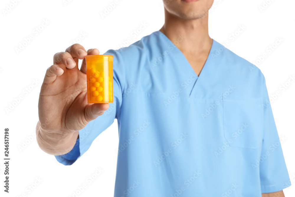 Male doctor holding pill bottle on white background, closeup. Medical object Male doctor holding pill bottle on white background, closeup. Medical object
