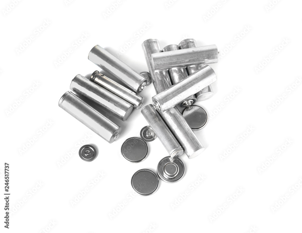 Used batteries on white background, top view. Recycling problem Used batteries on white background, top view. Recycling problem