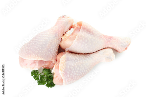 Raw chicken drumsticks with parsley on white background, top view. Fresh meat