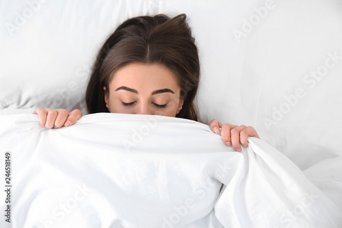 Young woman sleeping under blanket  top view. Bedtime
