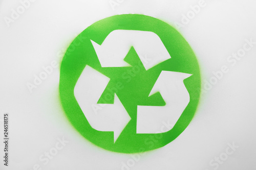 Recycling symbol painted on white paper, top view