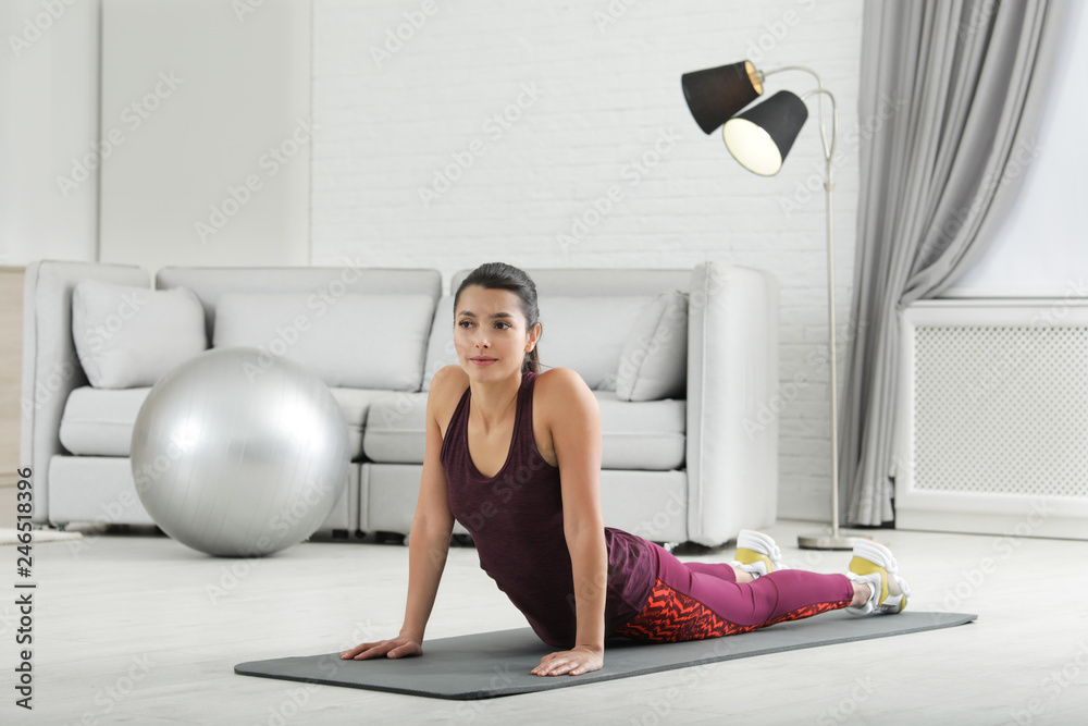 Young woman in fitness clothes doing exercise at home Young woman in fitness clothes doing exercise at home