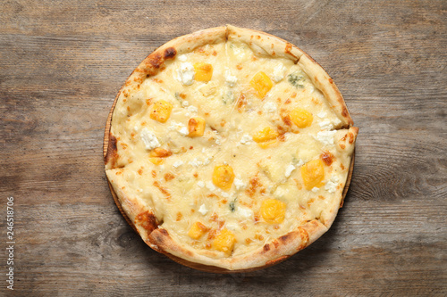 Hot cheese pizza Margherita on wooden background, top view