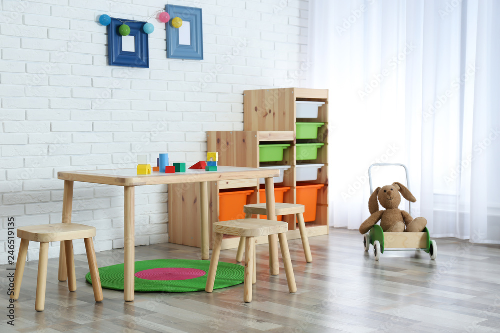 Fototapeta premium Modern child room interior with table and stools
