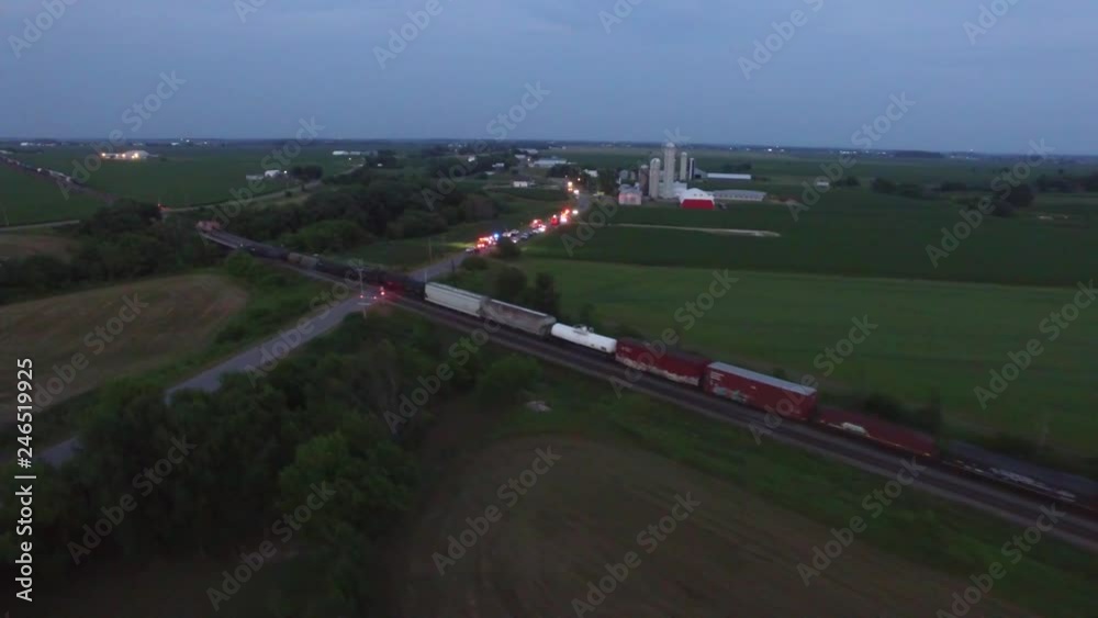 Train accident involving oil tanker cars near emergency vehicle lights