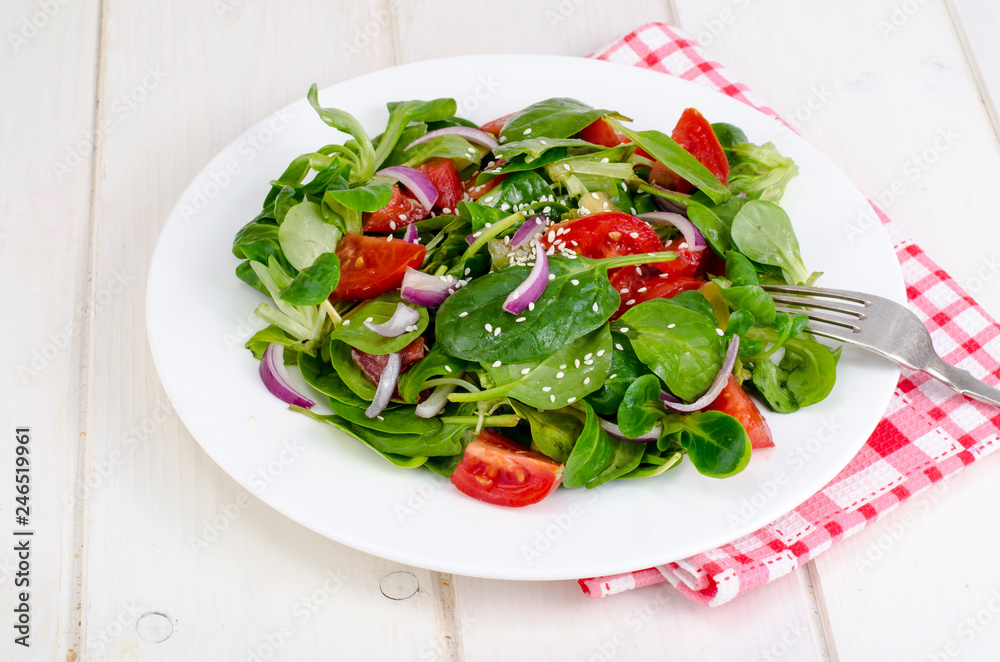 Concept of weight loss, healthy lifestyle. Light salad from fresh vegetables and herbs