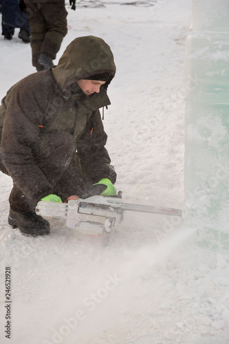 Portrait of an assembler with a chainsaw in his hands