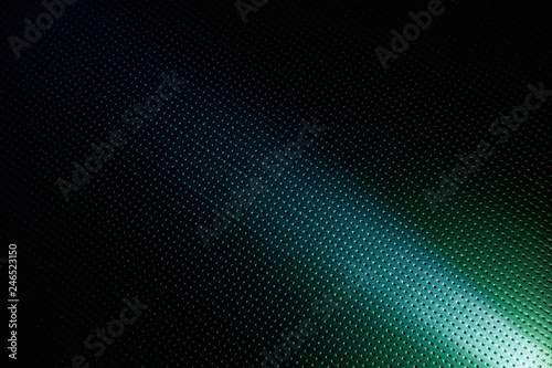 Diagonal bright beam of light on a blue background in a point with the transition to blackout