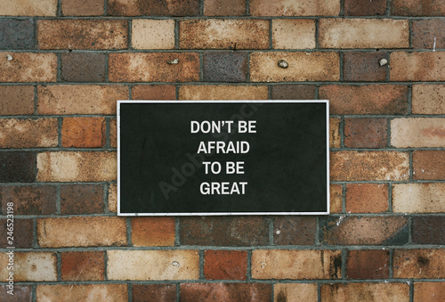 Don't be afraid to be great board mockup on a brick wall