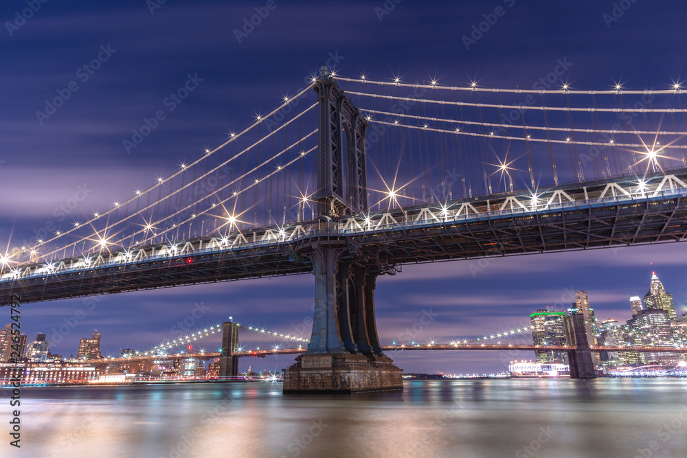 View on Manhattan Bridge at night from east river with long exposure