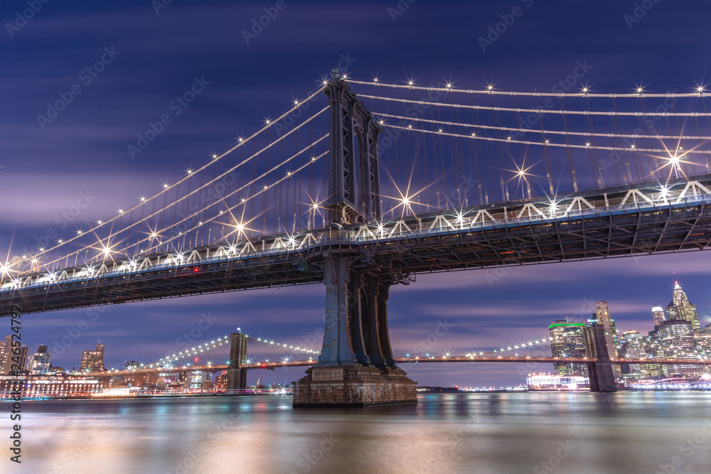 Fototapeta premium View on Manhattan Bridge at night from east river with long exposure
