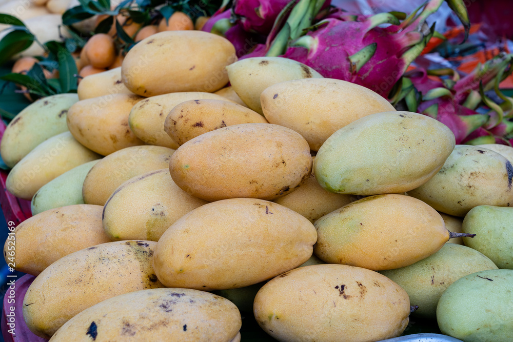 Mango, pitahaya and marian plum for sale on street market in Thailand. Tropical fruits close up Mango, pitahaya and marian plum for sale on street market in Thailand. Tropical fruits close up
