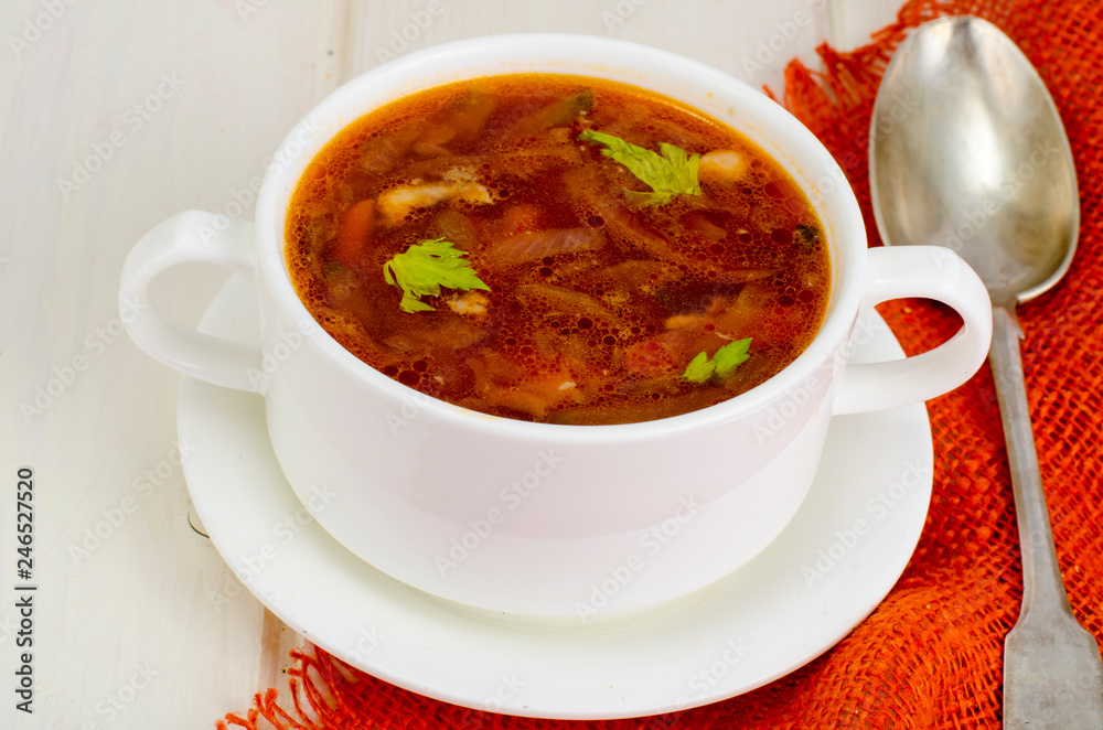 Soup with vegetables on white wooden surface Soup with vegetables on white wooden surface