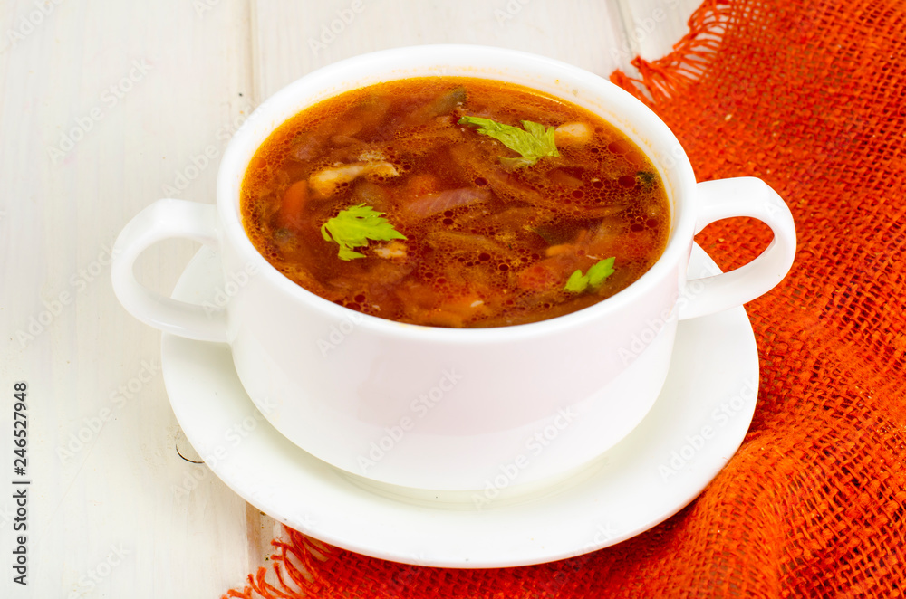 Soup with vegetables on white wooden surface Soup with vegetables on white wooden surface