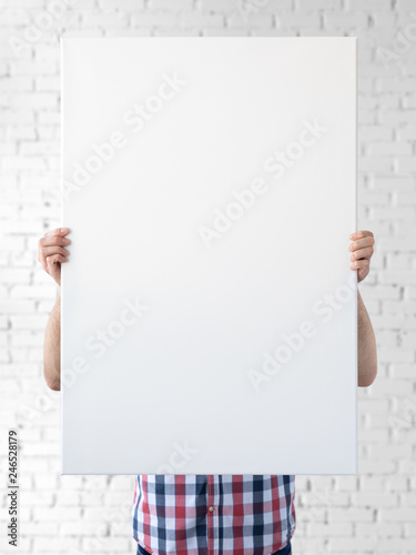 Holding canvas mockup. Photo Mockup. The man hold canvas. For canvas design. Frame size 24x36 (61x91cm). photo