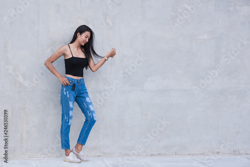 Beautiful Asian wearing Ripped jeans with copy space