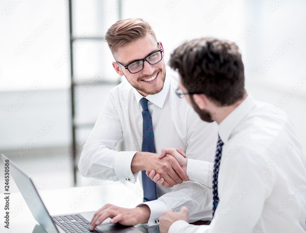 side view.smiling employees shaking hands side view.smiling employees shaking hands