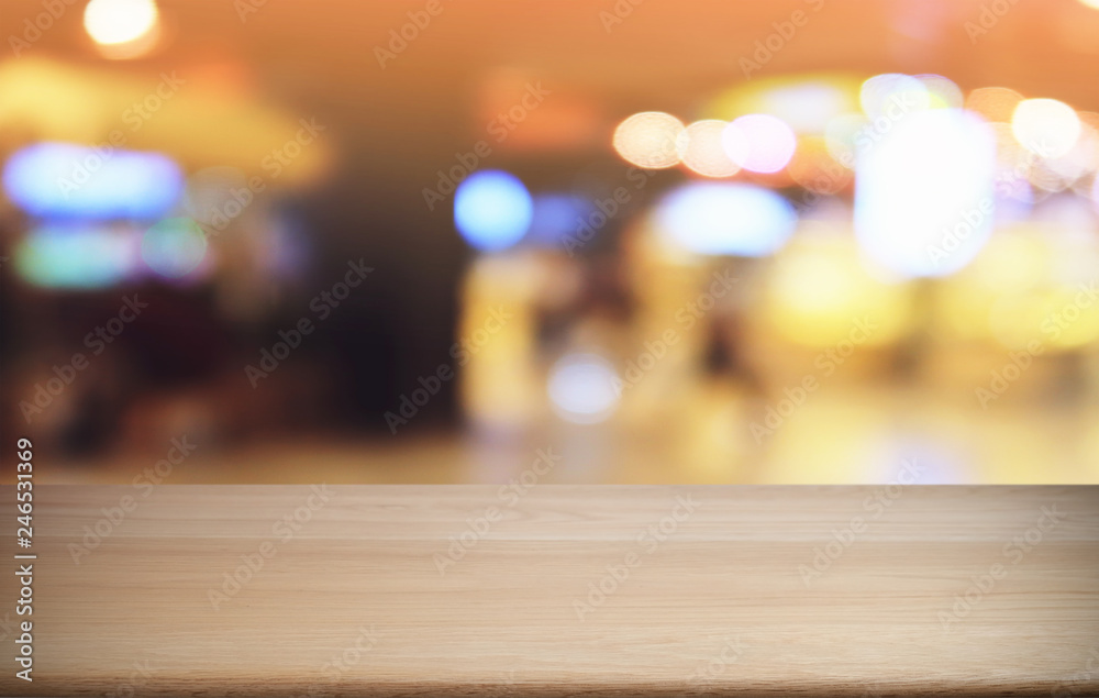 Empty dark wooden table in front of abstract blurred bokeh background of restaurant . can be used for display or montage your products.Mock up for space.