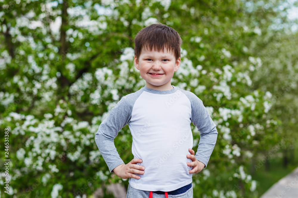 smiling boy on the background of a flowering Apple tree smiling boy on the background of a flowering Apple tree
