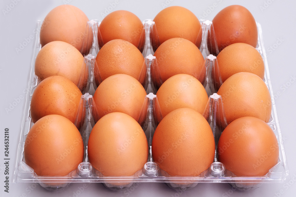 brown chicken eggs in plastic box on gray background, easter festive concept brown chicken eggs in plastic box on gray background, easter festive concept