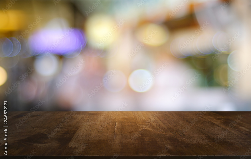 Empty dark wooden table in front of abstract blurred bokeh background of restaurant . can be used for display or montage your products.Mock up for space.