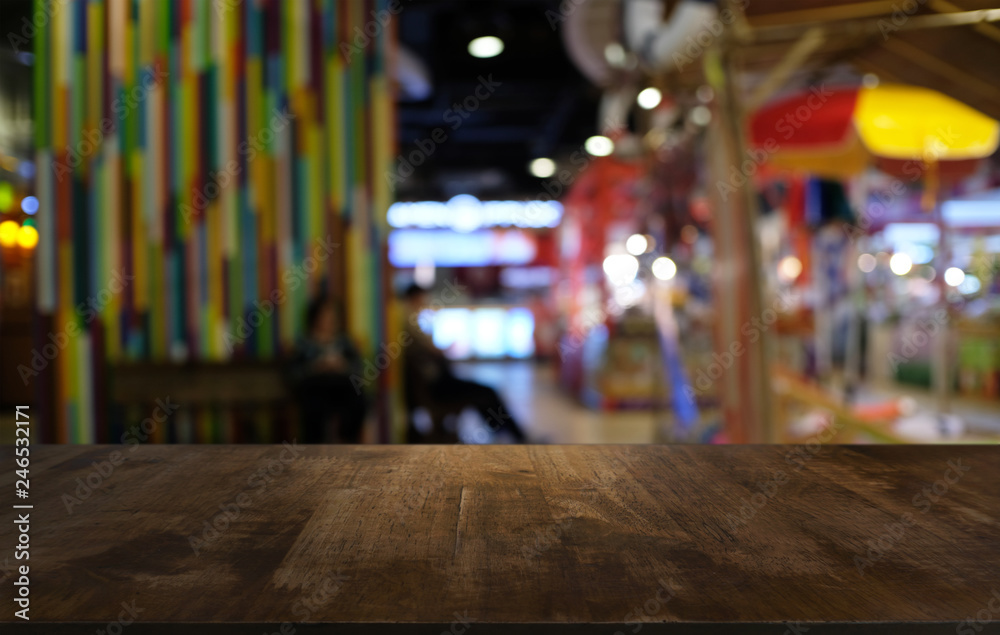 Empty dark wooden table in front of abstract blurred bokeh background of restaurant . can be used for display or montage your products.Mock up for space. Empty dark wooden table in front of abstract blurred bokeh background of restaurant . can be used for display or montage your products.Mock up for space.
