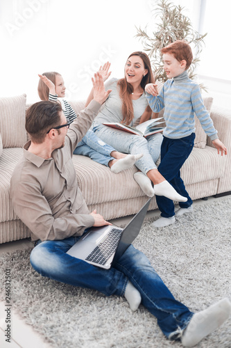 cheerful family spends their leisure time in their living room