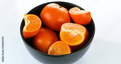 rotating fresh tangerines isolated on white background