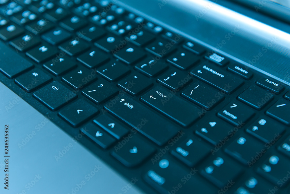 Close-up of notebook computer keyboard. selected focus on enter button.