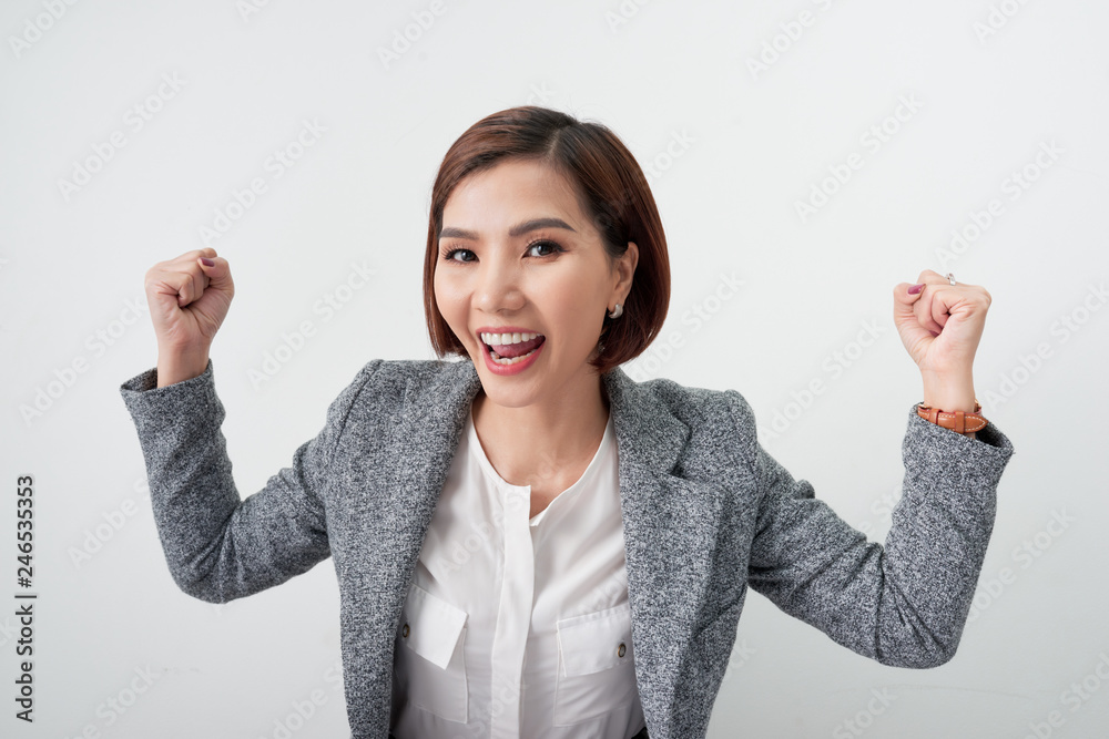 Εκτύπωση καμβά Successful business woman celebrating with arms up on white background, business
