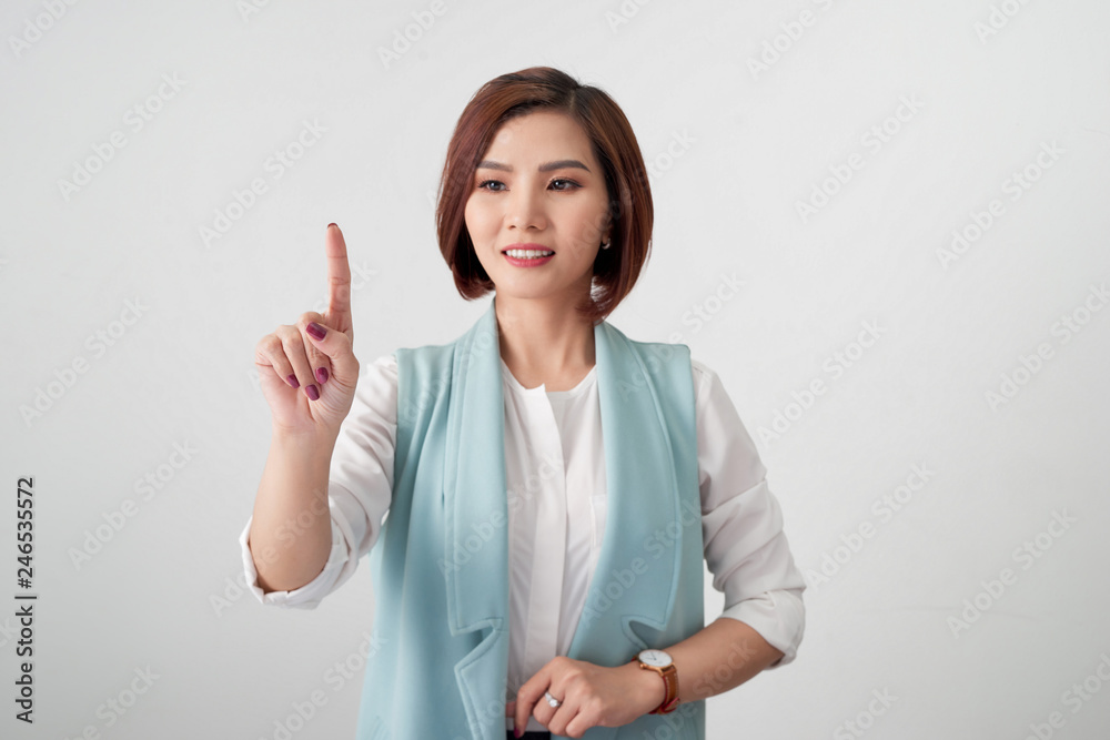 Young woman pointing at something on a white background Young woman pointing at something on a white background