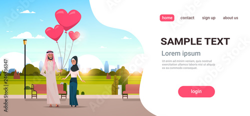 arab man giving woman pink heart shape air balloons happy valentines day concept arabic couple in love over city urban park cityscape background horizontal copy space