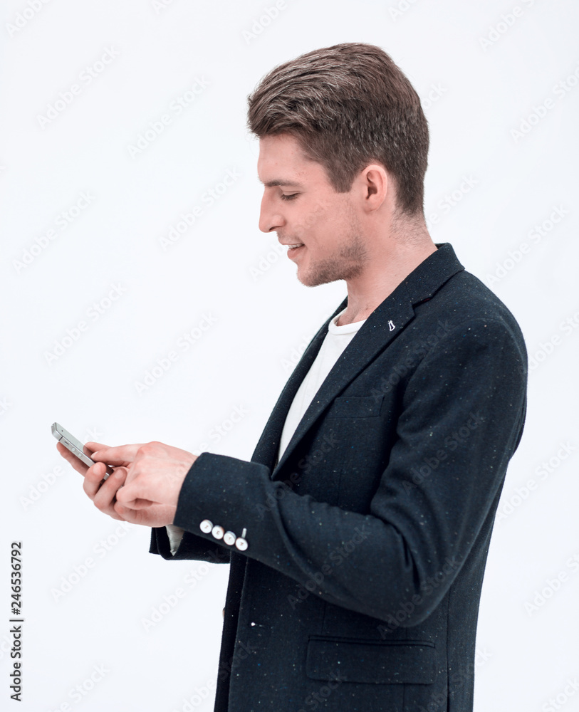 side view.successful businessman typing SMS on smartphone side view.successful businessman typing SMS on smartphone