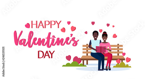 couple in love reading book together happy valentines day holiday concept african american man woman lovers sitting wooden bench greeting card isolated horizontal