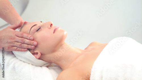 Young attractive woman getting spa treatment over white background.