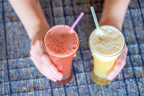 Wallpaper Mural Woman hands holding two glasses with pineapple and watermelon fresh juice, close up Torontodigital.ca