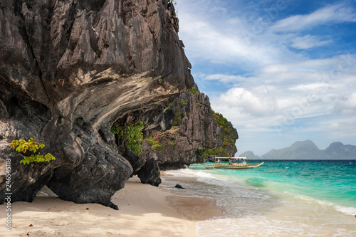Banca boat on the beach of Entalula island in El nido region of Palawan in the Philippines.