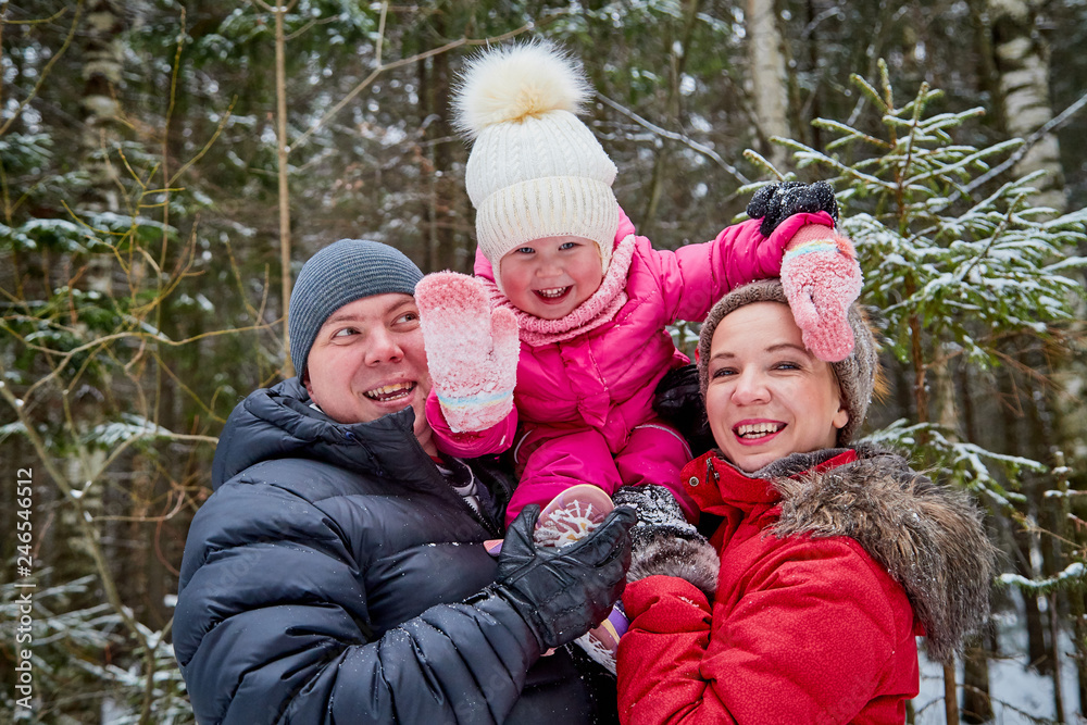 Ordinary family walking in a winter forest Ordinary family walking in a winter forest