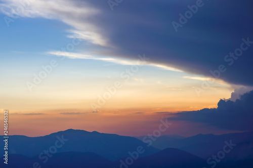 sunset in the clouds on a mountain background © photosaint
