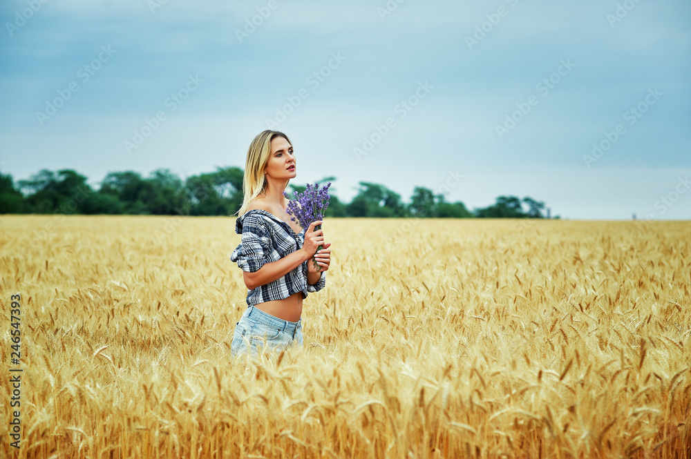 Young woman with a bouquet of lavender for a walk in the field Young woman with a bouquet of lavender for a walk in the field