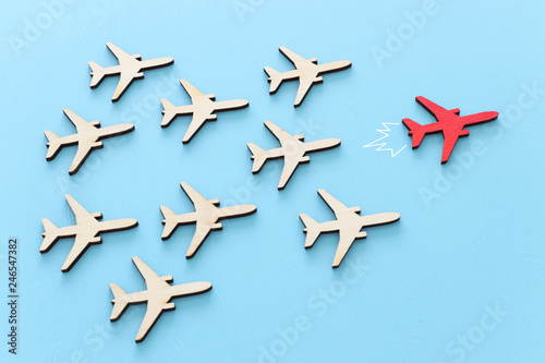 Fototapeta Leadership concept with airplanes on blue wooden background