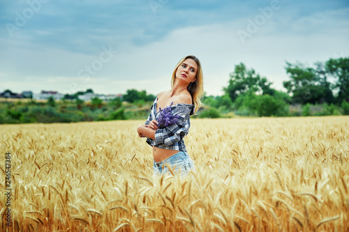 Young woman with a bouquet of lavender for a walk in the field