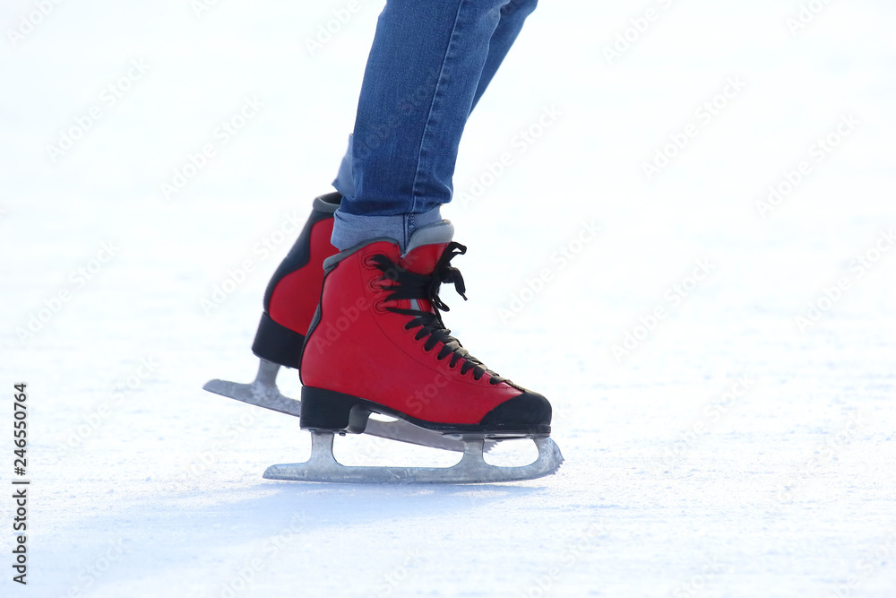 feet in red skates on an ice rink feet in red skates on an ice rink
