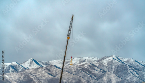 Crane with Lowe Peak and cloudy sky background